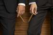 Mid section view of two businessmen holding cigars