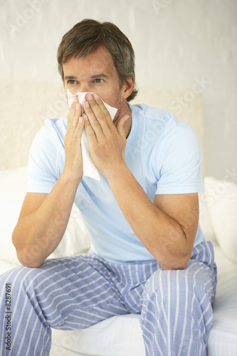 Photo: Mid adult man suffering from cold Mid adult man suffering from cold