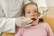Dentist examining a girl's teeth