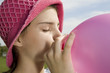Girl blowing balloon up