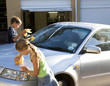 Young girl and boy washing a car