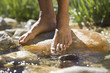 Close-up of feet in a stream