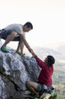 A climber helping another