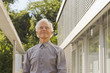 Senior man standing and grinning