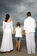 A couple with their daughter on a beach