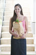 A young girl with a bag of shopping