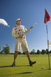 Mid adult man playing golf on a golf course and smiling