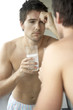Young man drinking a hangover remedy