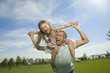 Happy father with daughter on his shoulders