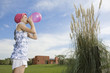 Girl blowing balloon up