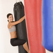 A young woman hugging a punch bag