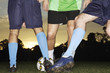 Low section view of soccer players playing soccer