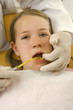 Dentist examining a girl's teeth