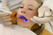 Dentist examining a girl's teeth