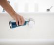 Pouring bath oil in a bath