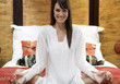 A woman sitting on a bed meditating
