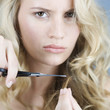 A young woman cutting her hair