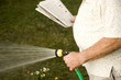 A senior man watering the garden