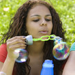 Girl blows bubbles