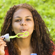Girl blows bubbles