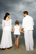 A couple with their daughter on a beach