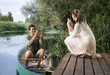 Foto: Young woman taking a photo of her partner's fishing success Young woman taking a photo of her partner's fishing success