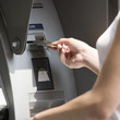 A young woman using a cash machine
