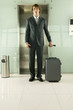 A businessman standing by the lift