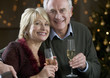 A senior couple drinking champagne