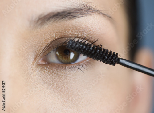 Photo: A young woman applying mascara A young woman applying mascara