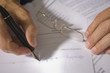 Close-up of a person's hand filling a form