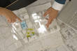 High angle view of a man and a woman's hands pointing at an architectural model