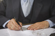 Mid section view of a lawyer filling a form
