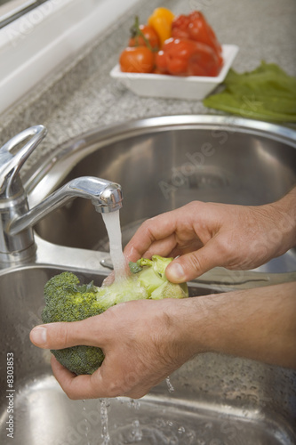Photo: Detail of hands washing broccoli Detail of hands washing broccoli