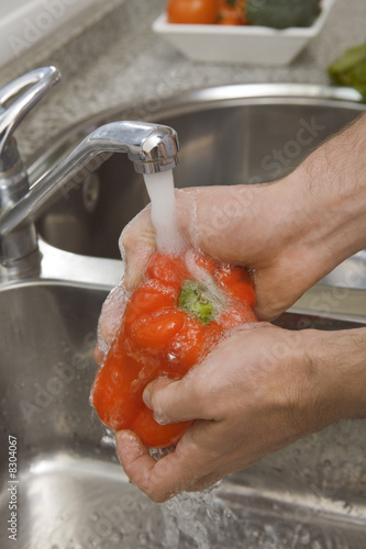 Photo: Detail of hands washing red pepper Detail of hands washing red pepper