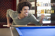 A young man playing pool