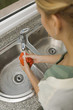 Young woman washing red pepper