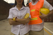 Two dock workers standing at a commercial dock