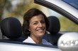A senior woman driving a car