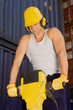 Photo: Mid adult man operating a jackhammer Mid adult man operating a jackhammer