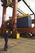 Cargo container being loaded on a truck at a commercial dock