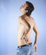 A young man holding his back