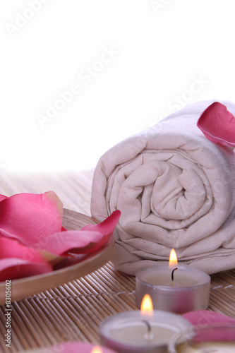 Photo: spa products with rose petals, oil container, towel and candles spa products with rose petals, oil container, towel and candles