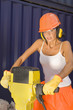 Portrait of a female dock worker holding a jackhammer