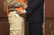 Mid section view of a businessman bribing a dock worker