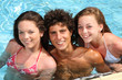 happy teenage friends in a swimming pool happy teenage friends in a swimming pool