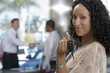 Photo: Salesman and customer shaking hands in car showroom, focus on woman holding key, smiling, portrait Salesman and customer shaking hands in car showroom, focus on woman holding key, smiling, portrait