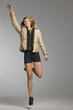 Young woman jumping in midair, studio shot