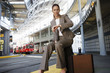 Photo: Businesswoman sitting on suitcase, waiting for city tram, checking time on wristwatch (surface level) Businesswoman sitting on suitcase, waiting for city tram, checking time on wristwatch (surface level)