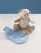 Close-up of a teddy bear with arm and head bandaged and medical equipments
